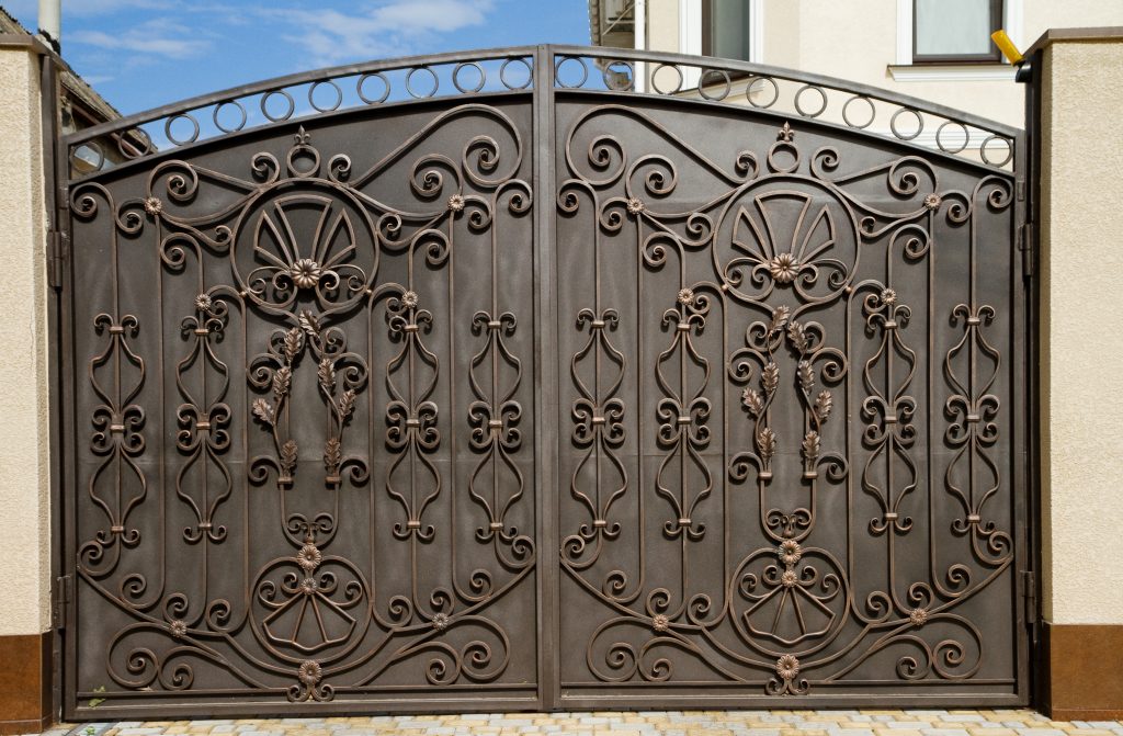 beautiful wrought iron doors in front of a home