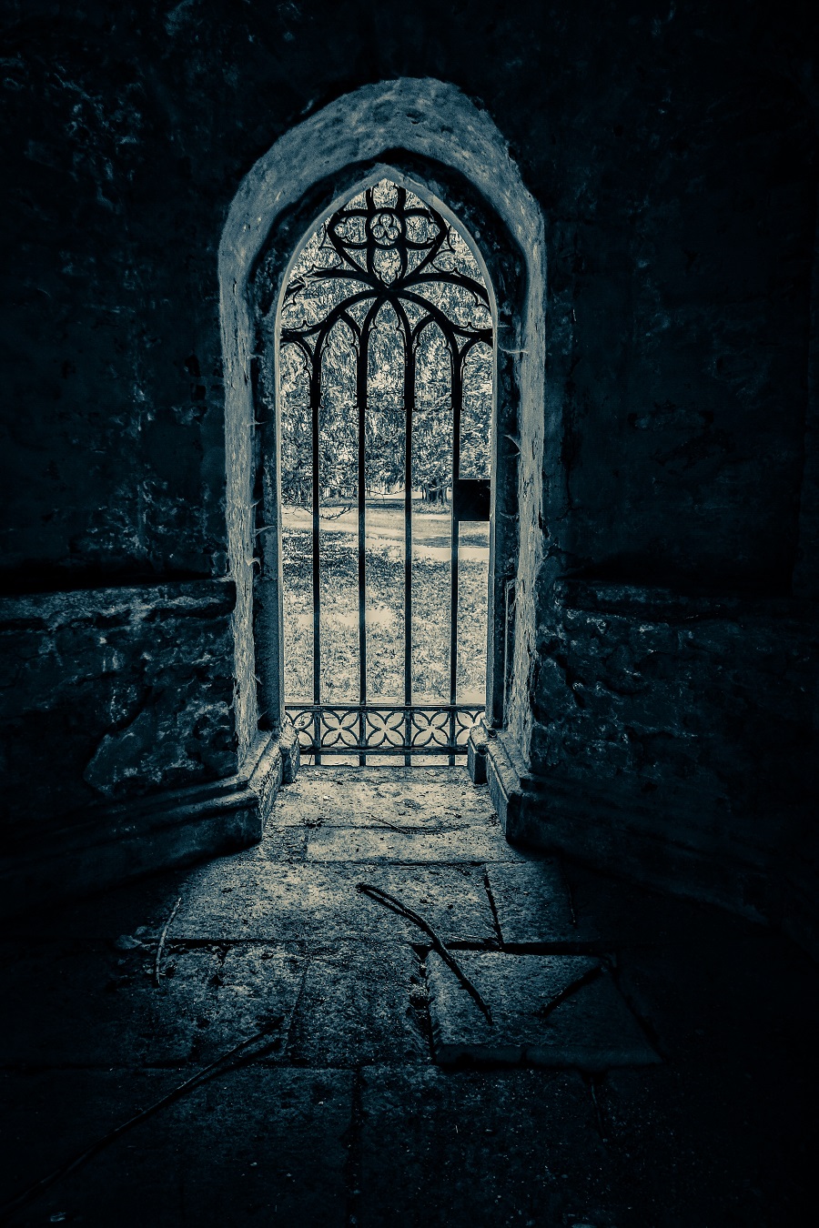 A vertical shot of a beautiful arch-shaped ancient door with a patterned lattice.