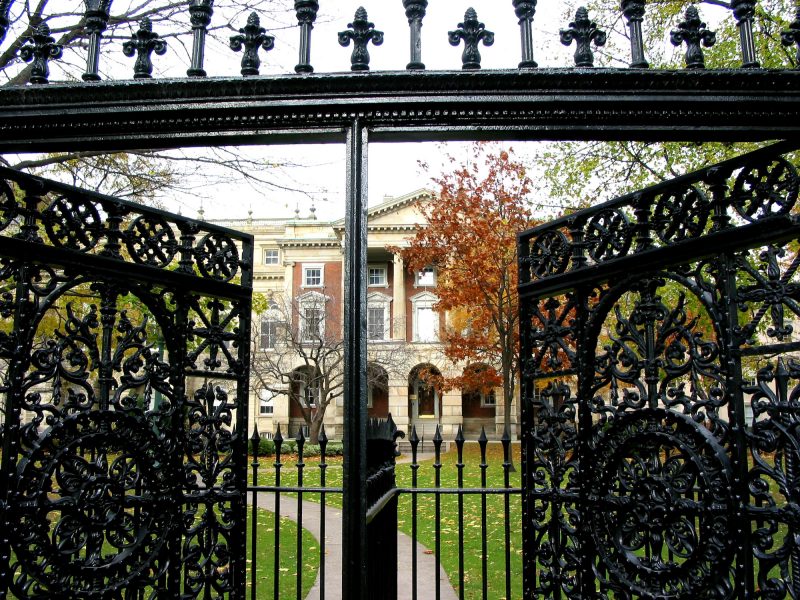 A beautiful wrought iron gate opening to reveal a grand estate